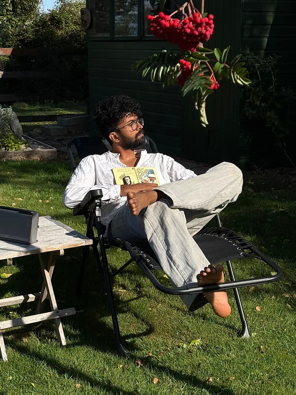 Bhagavath, who hosts at Gowreesam Homestay, reading in a garden in London